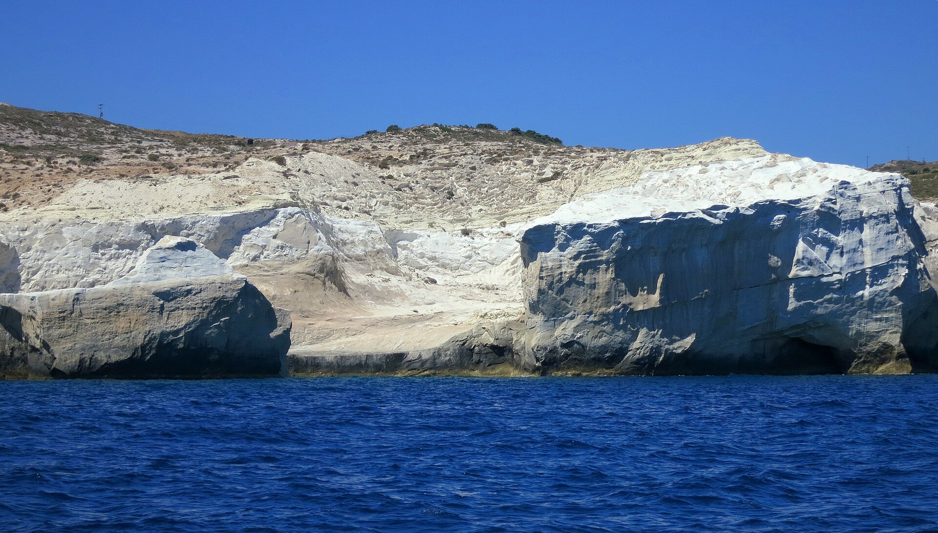 The white volcanic coast of Sarakiniko on Milos, seen from the water
